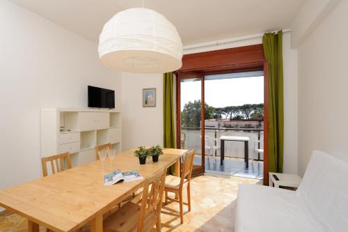 a dining room with a table and a large window at Tizi Apartments in Maiori