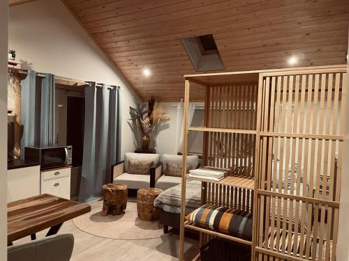 a living room with a crib and a table at Vakantiehuis de Heide in Bergen op Zoom