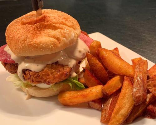 a chicken sandwich and french fries on a plate at The Black Lion Royal Hotel in Lampeter