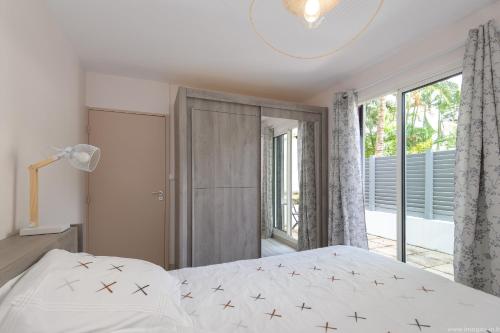 a bedroom with a bed and a large window at City Cocoon T2 rénové proche centre Saint Denis in Saint-Denis