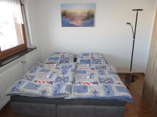 a bedroom with a bed with a quilt on it at Ferienwohnung Stadtblick in Bräunlingen