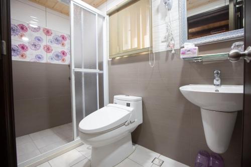 a bathroom with a toilet and a sink and a shower at King of Thailand in Jinhu