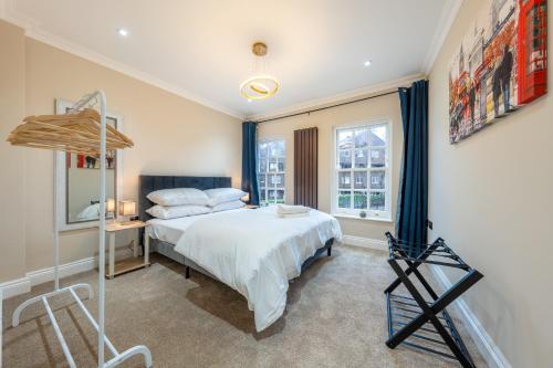 a bedroom with a large bed and a window at Canary Wharf Beautiful Modern House in London