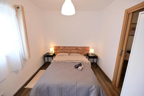 a bedroom with a bed with a stuffed animal on it at 4 Mares Apartamentos M in Loredo