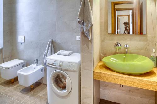 a bathroom with a sink and a washing machine at GINEVRA House in Levanto