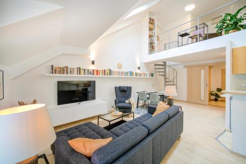 a living room with a couch and a tv at Residence Caesar in Brno