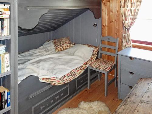 a bed in a room with a desk and a chair at 10 person holiday home in Svingvoll-By Traum in Svingvoll