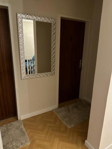 a room with a mirror on the wall and a door at Pension COLUMBIA inkl. Frühstück im Zentraum in Bad Gleichenberg