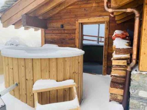 a wooden cabin with a sauna in the snow at Ski in out Swiss Alps Chalet Charelle by Jolidi in Nendaz