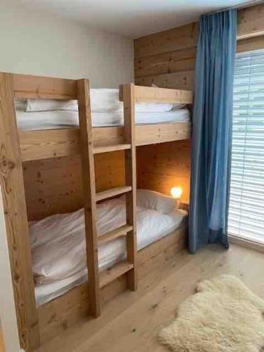 a bedroom with two bunk beds in a room at Ski in out Swiss Alps Chalet Charelle by Jolidi in Nendaz