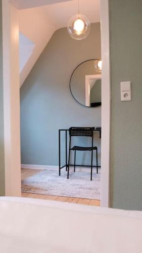 a dining room with a table and a chair at Stadtoase Design Wohnung in der Altstadt von Koblenz in Koblenz
