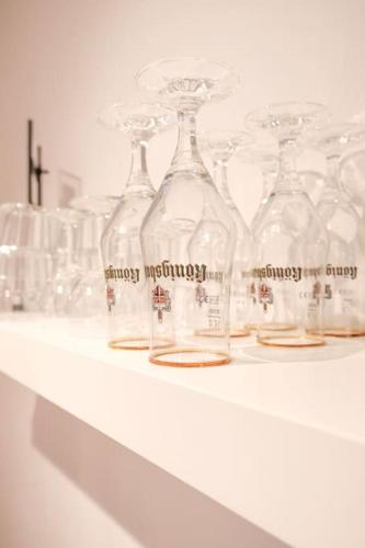 a row of glass bottles sitting on a shelf at Stadtoase Design Wohnung in der Altstadt von Koblenz in Koblenz