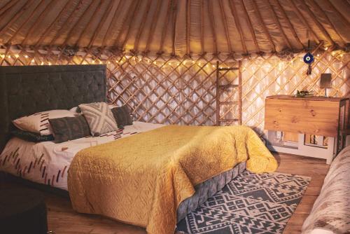 a bedroom with a bed in a yurt at Elf Yurt - Yurtopia in Aberystwyth