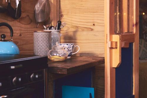 um balcão de cozinha com uma chávena sobre uma mesa em Elf Yurt - Yurtopia em Aberystwyth