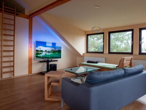 a living room with a couch and a table at Stifterfelsen Ferienwohnung in Sinzing