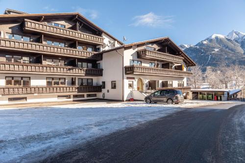 a large building with a car parked in front of it at Haus Excelsior Top 22 in Seefeld in Tirol