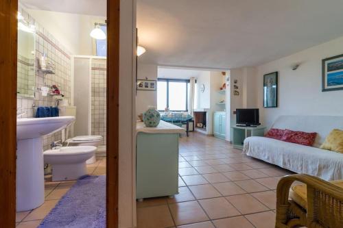 a bathroom with a sink and a living room at Casa Lentisco in Chia