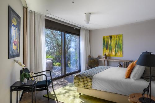 a bedroom with a bed and a large window at Captivating 5-Bedr Villa close Navarino Dunes Golf in Tragána
