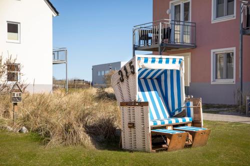 a stack of chairs sitting in front of a house at TUI BLUE Sylt in Rantum