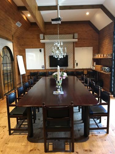 a large dining room with a large table and chairs at Bykrogen in Österslöv