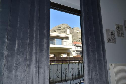 a window with a view of a building at Meteora House with a view in Kalabaka