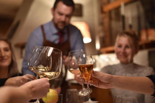 a group of people holding up glasses of wine at Bykrogen in Österslöv