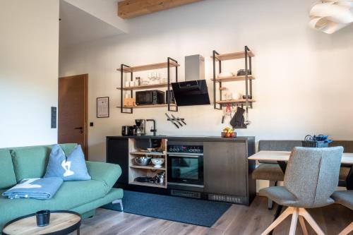 a living room with a couch and a table at Alte Bildhauerei in Aurach bei Kitzbuhel