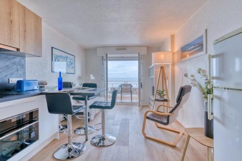 a kitchen with a desk and chairs in a room at Michelet in Arcachon