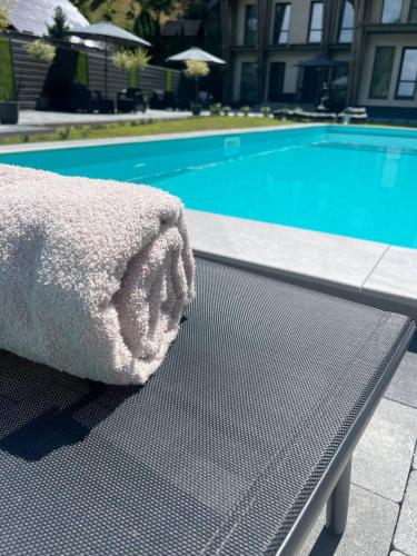 a bed sitting on a table next to a swimming pool at Sandal in Shaian