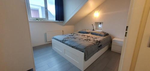 - une chambre avec un lit et une fenêtre dans l'établissement Appartement Uniekappart, à Uitgeest