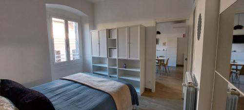 a bedroom with a bed and a room with a table at Alba Roma Holiday Home in Rome