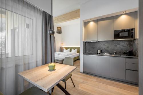 a kitchen and a living room with a wooden table at Camping Sölden Apartments in Sölden