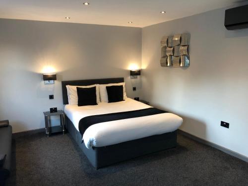 a bedroom with a large bed with two pillows at The Castle in Norwich