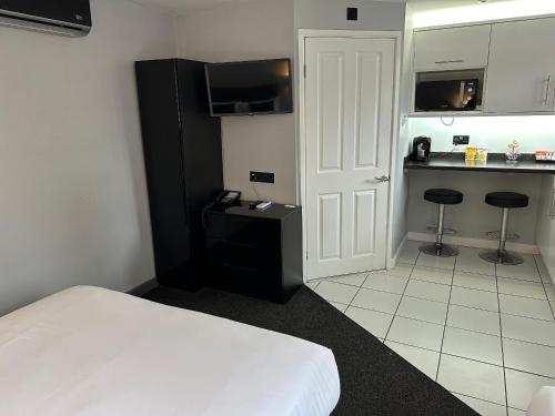 a hotel room with a bed and a kitchen at The Castle in Norwich