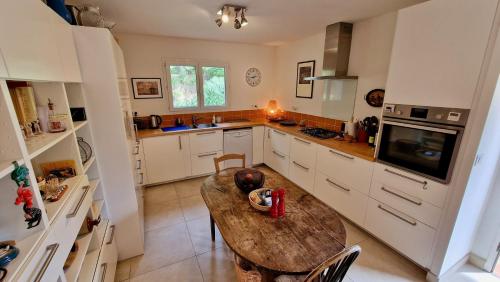 a kitchen with a wooden table in the middle at Villa Linda in Margon