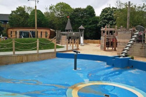 an empty playground with a slide at Sunny Seaside Beach House Lytham Centre sleeps 8 in Lytham St Annes