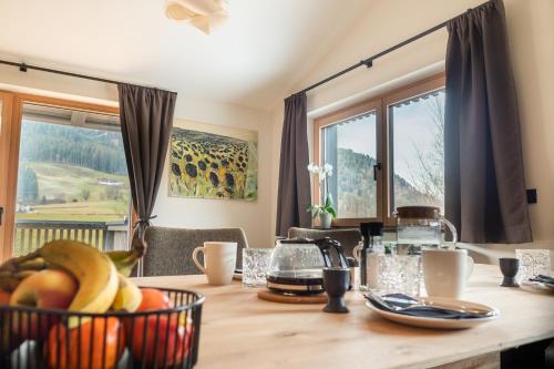 a dining room table with fruits in baskets on it at Alte Bildhauerei in Aurach bei Kitzbuhel