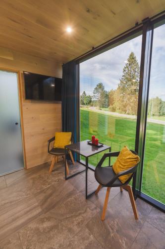 a room with a table and chairs and a large window at Kääriku ÖÖD HÖTELS in Kääriku