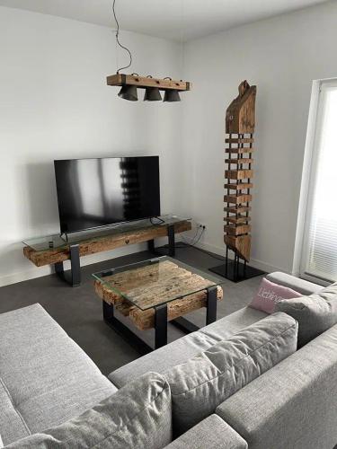 a living room with a couch and a coffee table at Ferienhof Elbaue in Schönebeck