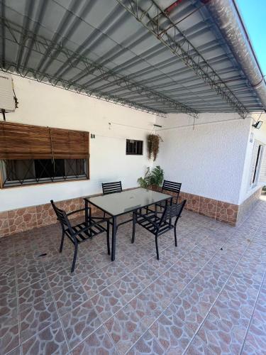 a patio with a table and chairs in a building at Martin Fierro in La Floresta