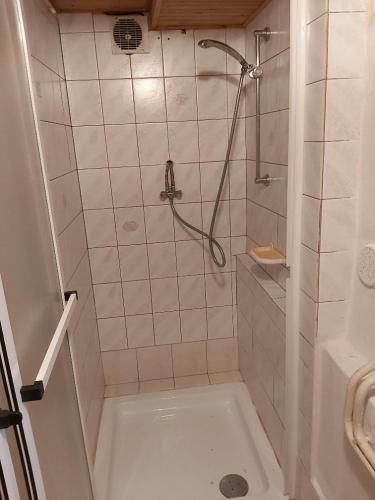 a bathroom with a shower and a bath tub at Ubytování v retro chalupě Na Věčnosti in Tanvald
