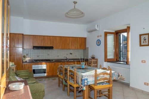 a kitchen with a table and chairs in a room at Sole Holiday House in Pontone