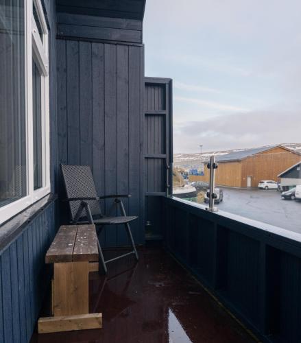 a chair sitting on the balcony of a house at Unique Boathouse - Central - Kajak - Fitness in Strendur