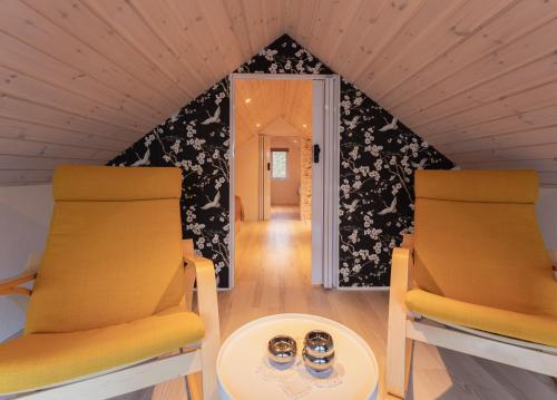 two chairs and a table in a room at Unique Boathouse - Central - Kajak - Fitness in Strendur
