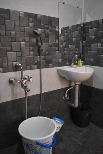 a bathroom with a toilet and a sink at DIAMOND HILL VIEW in Ketti