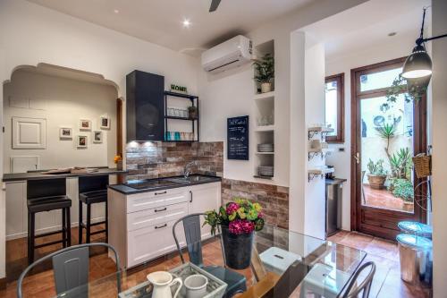 a kitchen with a glass table and a counter at Spanish Steps Miracle Suite in Rome