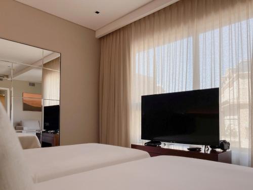 a hotel room with a bed and a large mirror at Cottage Carrasco in Montevideo