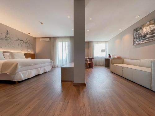 a large bedroom with a bed and a couch at Cottage Carrasco in Montevideo