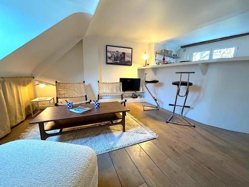 un salon avec une table et un canapé dans l'établissement Le Penthouse Picardie, à Paris