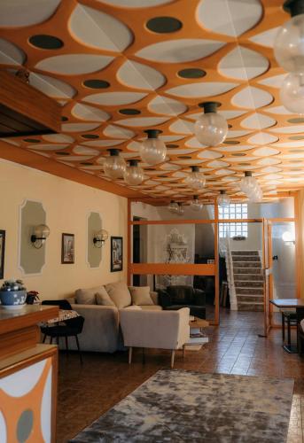 a living room with a coffered ceiling with circles on it at Pension COLUMBIA inkl. Frühstück im Zentraum in Bad Gleichenberg